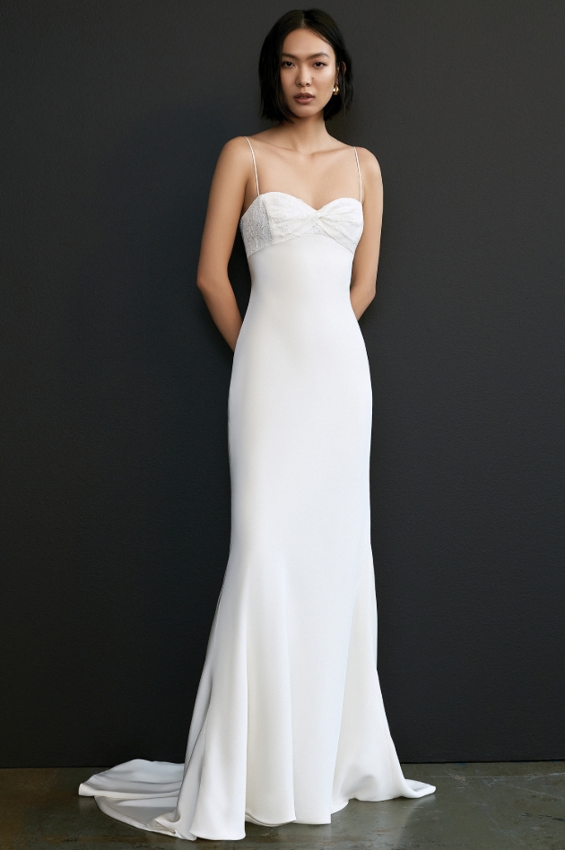 Model wears a slimline plain Savannah Miller white gown