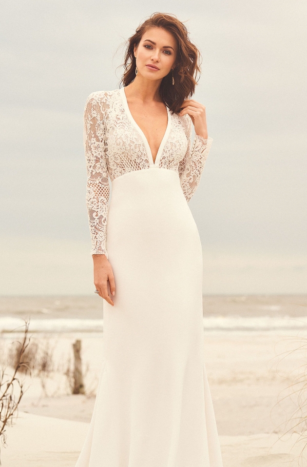 Bride wears fit and flare style white wedding gown