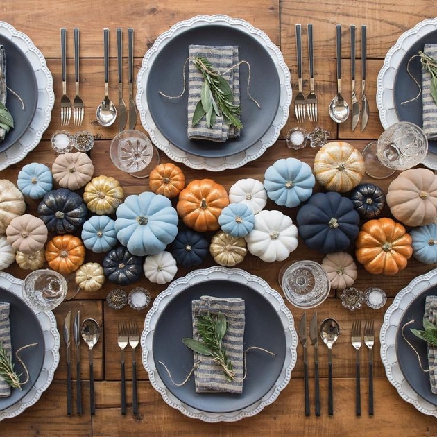  tablescape with lots of little blue and orange pumpkins with blue and whit crockery
