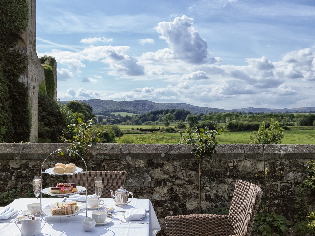 table and chair with afternoon tea on the terrace with castle views