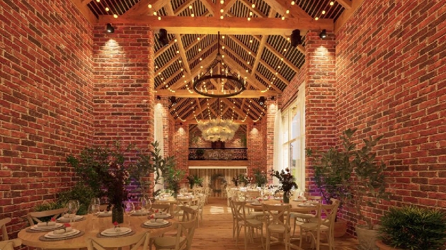 A brick building with a large roof full of round tables