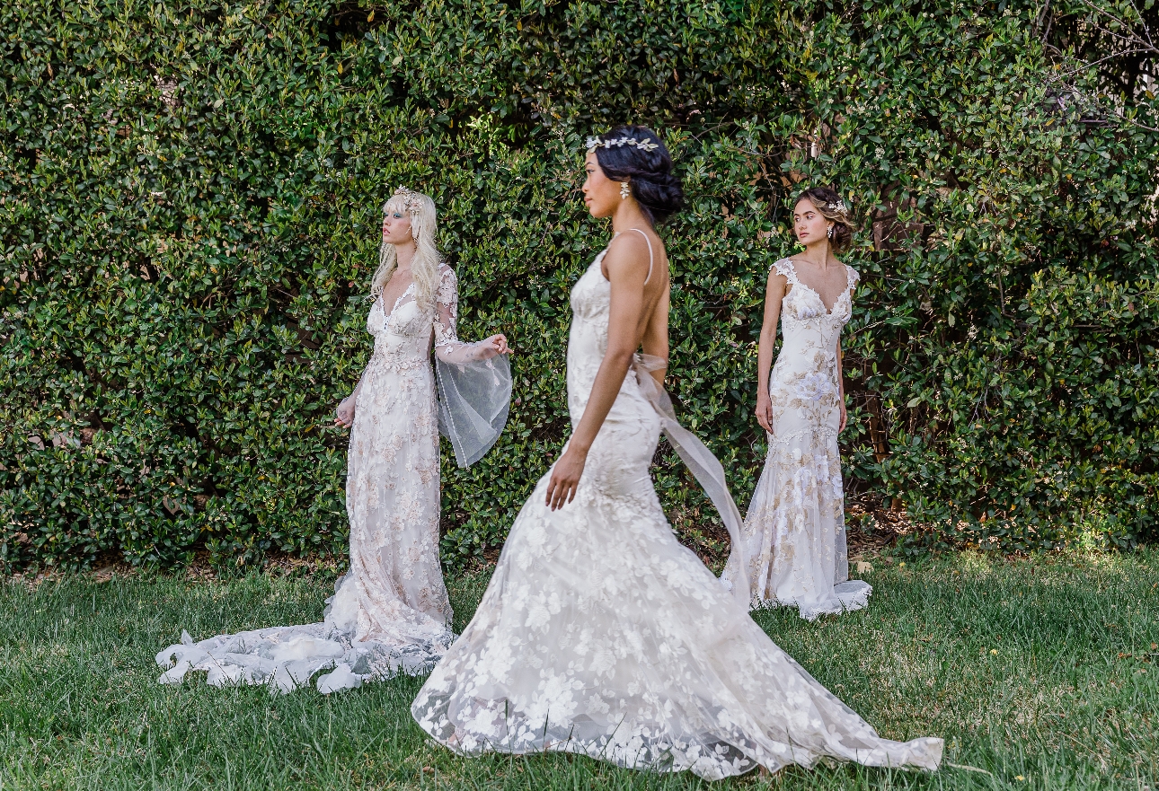 three models in ethereal wedding dresses with floral applique