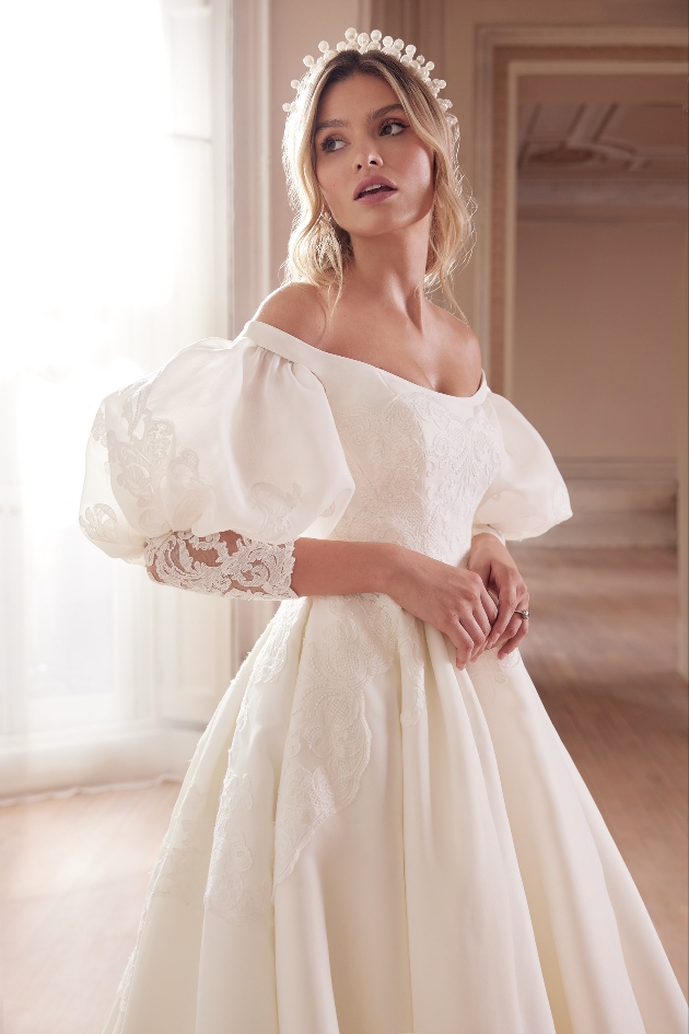 model in satin dress, lace overlay, puffle ball sleeves and lace detail