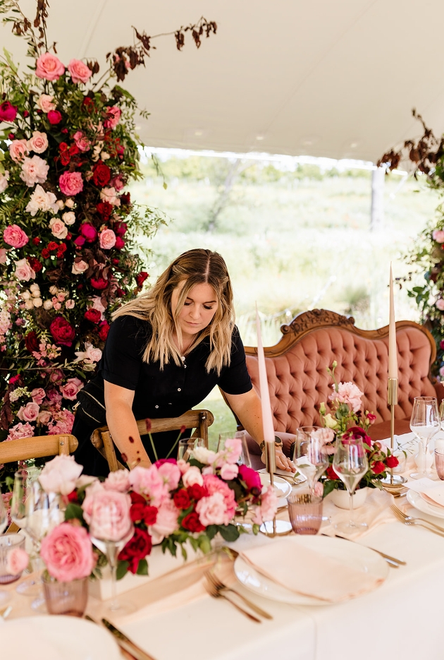 Georgie setting a styled table at a wedding